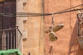 An old pair of shoes hanging on an electric cable in height Royalty Free Stock Photo