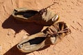 Old pair of shoes on sand Royalty Free Stock Photo