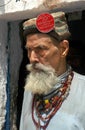 Old Pakistani man with a black beard smoking a cigarette in Peshawar, Pakistan