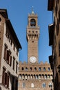 Old Palace called Palazzo Vecchio and clock tower with blue sky in Signoria square in Florence Italy Royalty Free Stock Photo