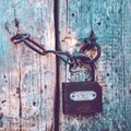Old pale blue wooden door with a lock and a chain. Boho style Royalty Free Stock Photo