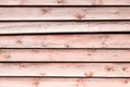 Old pale red wooden wall with peeling paint Royalty Free Stock Photo