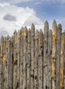 Old palisade of sharpened logs against the sky Royalty Free Stock Photo