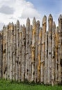 Old palisade of sharpened logs against the sky Royalty Free Stock Photo