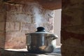 Old pan on a Russian brick stove, steam from a crutch