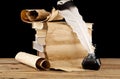 Old paper, books and inkwell with a pen on a black background Royalty Free Stock Photo