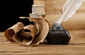 Old paper, books and inkwell with a pen on a black background Royalty Free Stock Photo