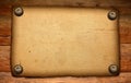 Old paper on brown wood texture Royalty Free Stock Photo