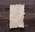Old paper on brown wood texture Royalty Free Stock Photo