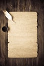 Old paper on brown wood texture with feather and ink Royalty Free Stock Photo