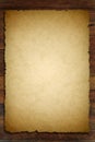 Old paper on brown wood texture Royalty Free Stock Photo