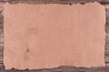 Old paper on brown wood texture with natural patterns. Royalty Free Stock Photo