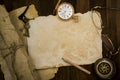 Old paper, compass, pocket watch on wooden background