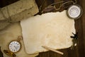 Old paper, compass, pocket watch on wooden background