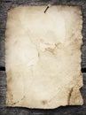 Old paper nailed to a wooden background