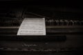 Old paper notes lie on an abandoned piano. Royalty Free Stock Photo