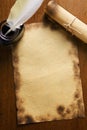 Old paper, quill pen and scroll on wooden paper Royalty Free Stock Photo