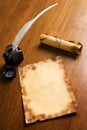 Old paper, quill pen and scroll on wooden table Royalty Free Stock Photo