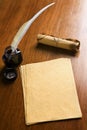 Old paper, quill pen and scroll on wooden table Royalty Free Stock Photo