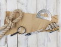 Old paper, rope, magnifying glass and model classic boat on wood background Royalty Free Stock Photo