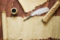 Old paper, scroll and quill pen on wooden paper with copy space Royalty Free Stock Photo