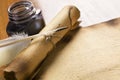 Old paper, scroll and quill on wooden table