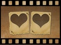 Old paper slides in the form of hearts on grunge background