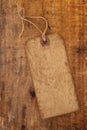 Old paper tag with string on grunge wooden table Royalty Free Stock Photo