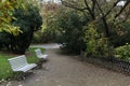 An empty alley with white benches in an autumn Park. Prague, Czech Republic, Central Europe. Royalty Free Stock Photo