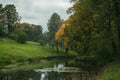 The old park with a small reservoir and century trees, a subject - seasons, art processing. Royalty Free Stock Photo