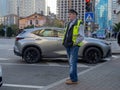 Old parking attendant. Man at work. Street work. The roadway. Looking at cars