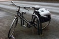 Old parking bicycle under snow at street. Abandoned bike. Royalty Free Stock Photo