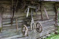 Old partly broken rural wagon undercarriage hangs on wooden wall Royalty Free Stock Photo