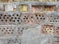 Old partly destroyed red brick wall with crumbling plaster outdoors Royalty Free Stock Photo