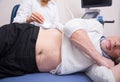 Old patient having ultrasonic scanning of abdomen in the clinic Royalty Free Stock Photo