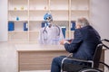 Old patient in wheel-chair visiting devil doctor Royalty Free Stock Photo