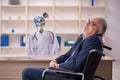 Old patient in wheel-chair visiting devil doctor Royalty Free Stock Photo