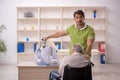 Old patient in wheel-chair visiting skeleton doctor Royalty Free Stock Photo