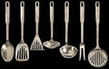 Old Patinated Seven Pieces Stainless Steel Kitchen Utensils Set Isolated On Black Background Royalty Free Stock Photo