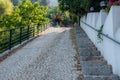 Old paved road and pedestrian stairs surrounded by greenery