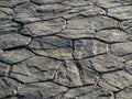 The old pavement is lined with large, rough stones of an unusual shape. Abstract background of pavement