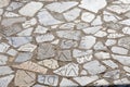 Old pavement made of marble pieces with latin letters