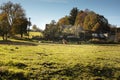 Old peasant house in beautiful natural surroundings.Horses grazing on the green field.Sunny autumn day. Royalty Free Stock Photo