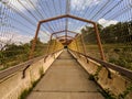 Old pedestrian walkway over freeway being overgrown by weeds