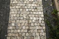 Old pedestrian walkway on the street paved with stones