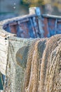 An old peeling fishing boat stands on the shore. Royalty Free Stock Photo