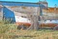 An old peeling fishing boat stands on the shore. Royalty Free Stock Photo