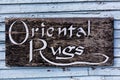 Old peeling Oriental Rugs sign