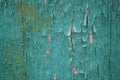 Old peeling paint on a wooden board. Green painted cracked board. Royalty Free Stock Photo