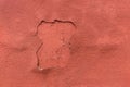 Old peeling red plaster with weathered worn wall texture background Royalty Free Stock Photo